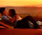 Romantic Lovers On Car And Sunset